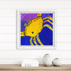 Framed artwork of a yellow creature with a purple and blue background on a white wall.