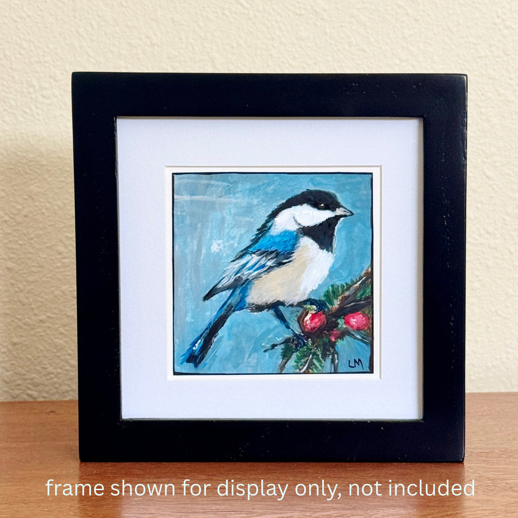 Bird and Berries acrylic painting by Lori McKinnon, displayed with a white mat in a black frame on a wooden surface. Frame not included