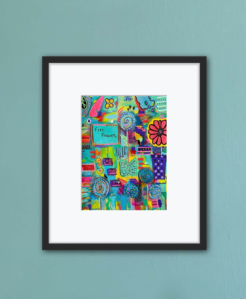 Framed colorful abstract art print on a light blue wall