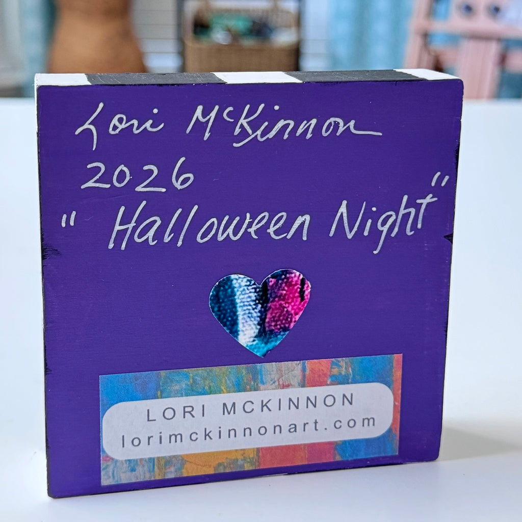 wood block with art showing the artist's name 'Lori McKinnon' and a colorful heart