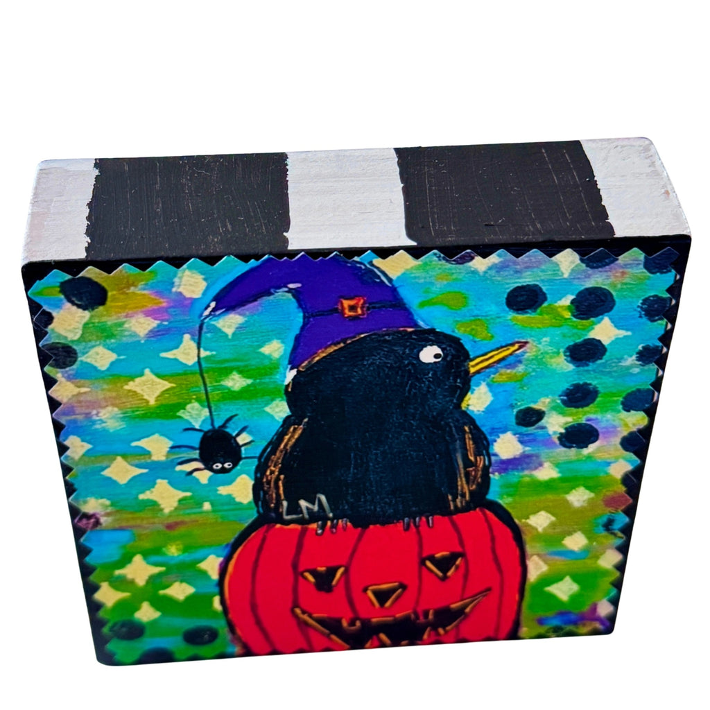 Halloween painting on a wood block and the sides are all painted with black and white stripes