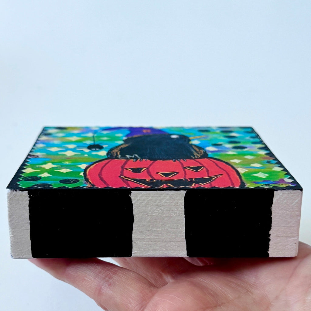 Halloween painting on a wood block and the sides are all painted with black and white stripes