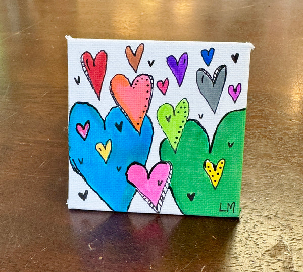 3x3 magnet with multi color hearts on white background