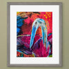 Framed abstract art print featuring a stylized heron with a long beak against a vivid red, pink, and blue background, set in a gray frame with a white mat.