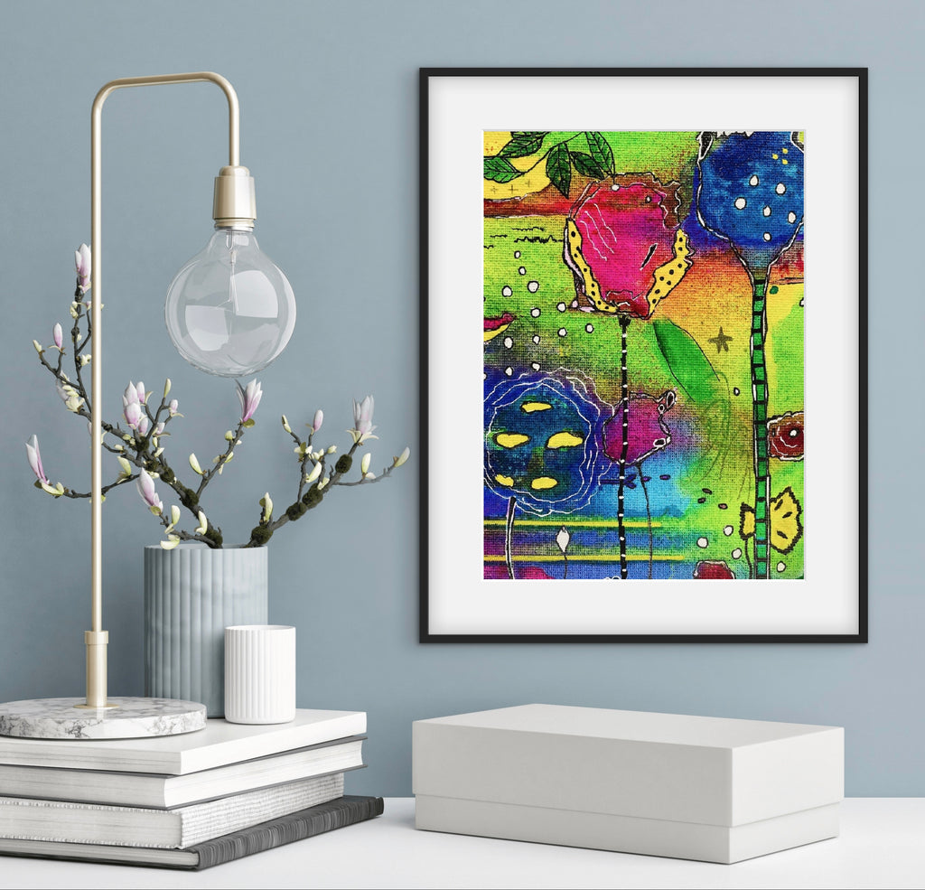 Decorative interior setting with a lamp, books, and colorful abstract art on a gray wall.