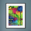 Framed abstract artwork with colorful flowers on a gray wall