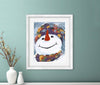 Framed artwork of a colorful snowman on a teal wall with decorative vases below.