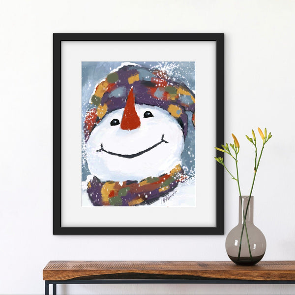 Framed artwork of a colorful snowman on a wall above a wooden shelf with a vase.