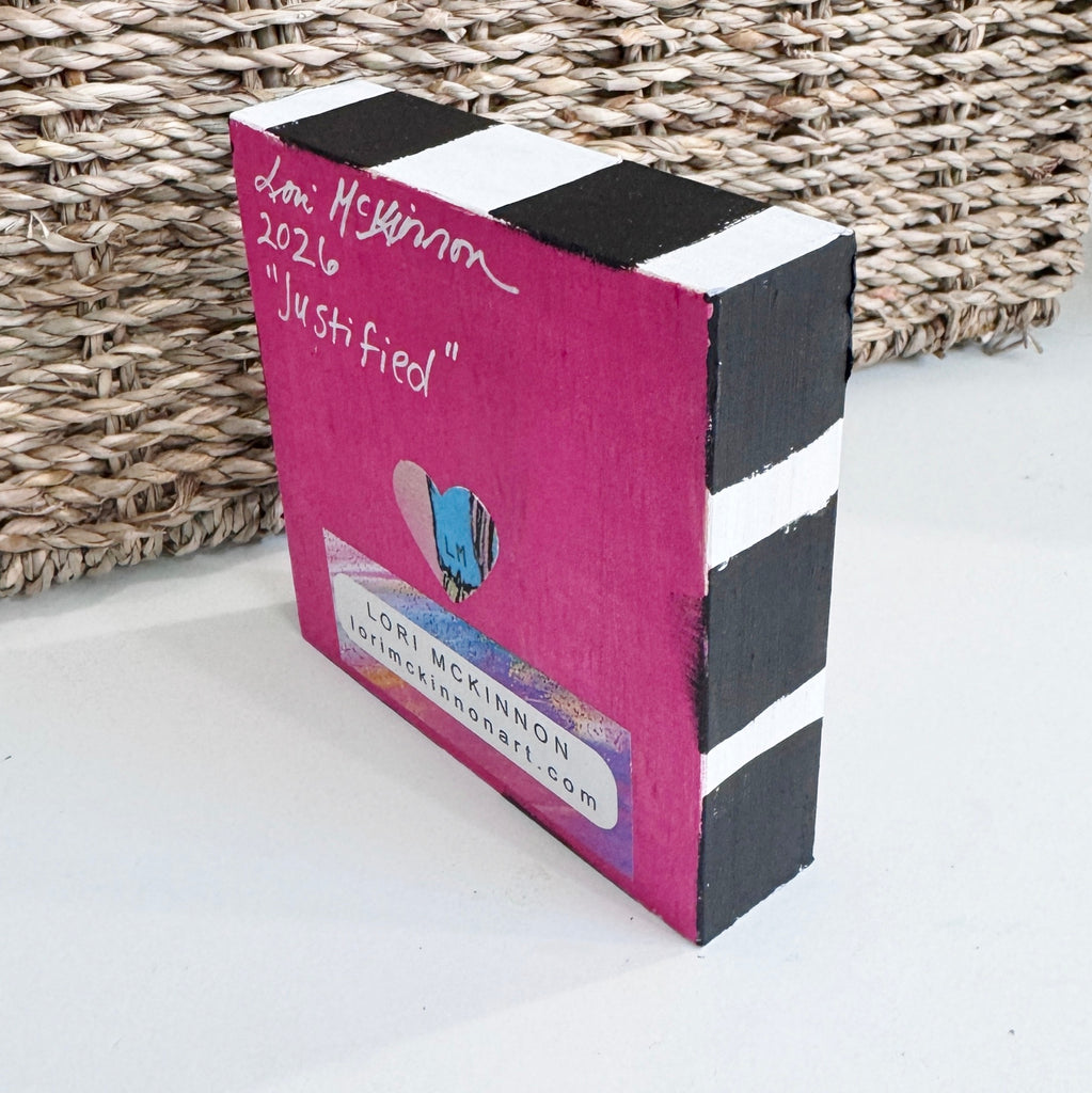 painted wood block on a table in front of a basket
