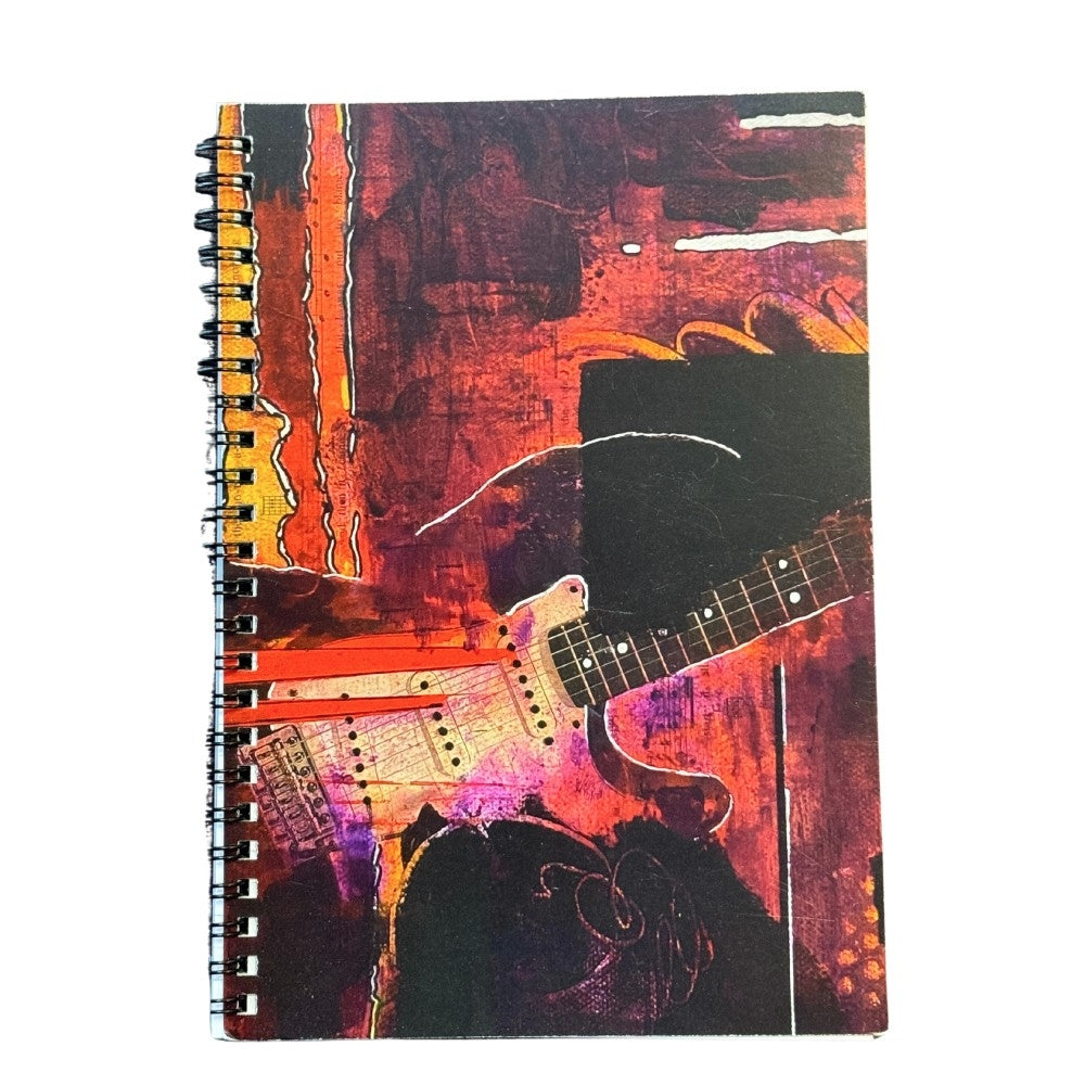 Notebook with a guitar design on a colorful abstract background