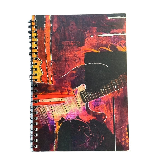 Notebook with a guitar design on a colorful abstract background