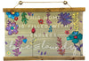Hand painted floral wall hanging with text "love and laundry" saying