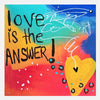 A colorful square art print featuring the text 'love is the ANSWER!' in black hand-lettered font over a bright abstract background. The design includes a large yellow heart, white scribbled line art, and blue and red gradient areas.
