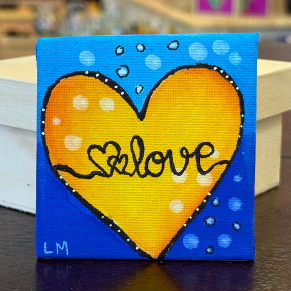 magnet with yellow and black love artwork on blue background