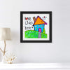 Framed artwork with a colorful house and 'Love Lives Here' text on a white wall.