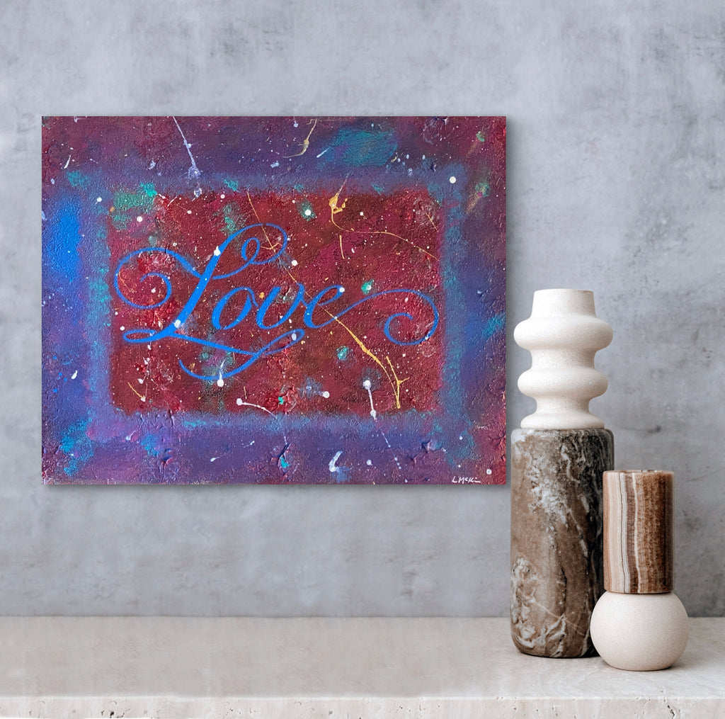 Colorful abstract painting with 'Love' text on a gray wall, accompanied by decorative vases.