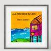 Framed artwork with a colorful depiction of a house, heart, and text 'All you need is love.