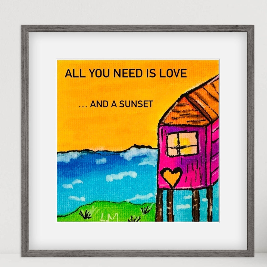 Framed artwork with a colorful depiction of a house, heart, and text 'All you need is love.