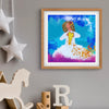 Framed colorful artwork of an angel holding a heart on a gray wall with decorative items.