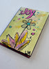 small painting with a flower and the word 'joy'