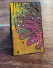 small painted bookmark sitting on a table