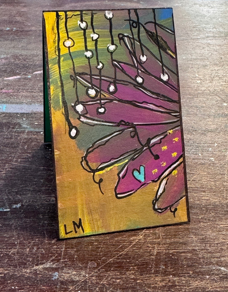 small painted bookmark sitting on a table
