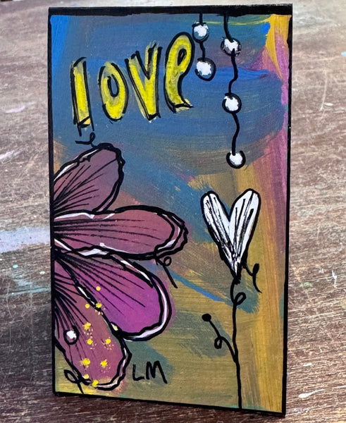small painted bookmark on a wooden table