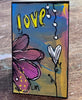 small painted bookmark on a wooden table