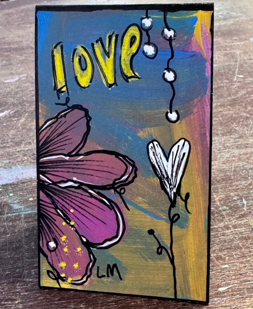 small painted bookmark on a wooden table