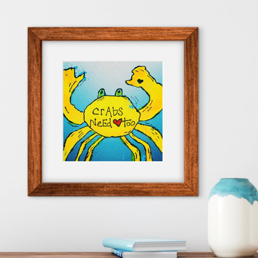 yellow crab artwork with text saying "crabs need love too" in a brown frame