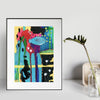 abstract underwater painting sitting on a table next to a plant