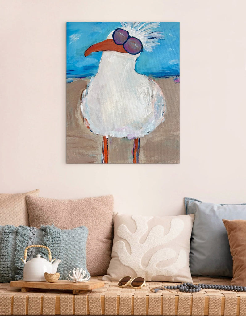 Painting of a bird with sunglasses on a wall above a couch.