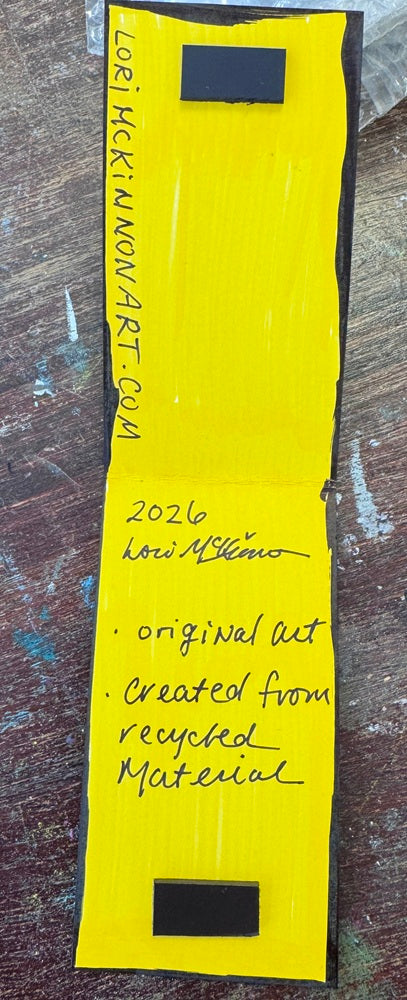 A painted bookmark showing inside with magnets and artist signature Lori McKinnon