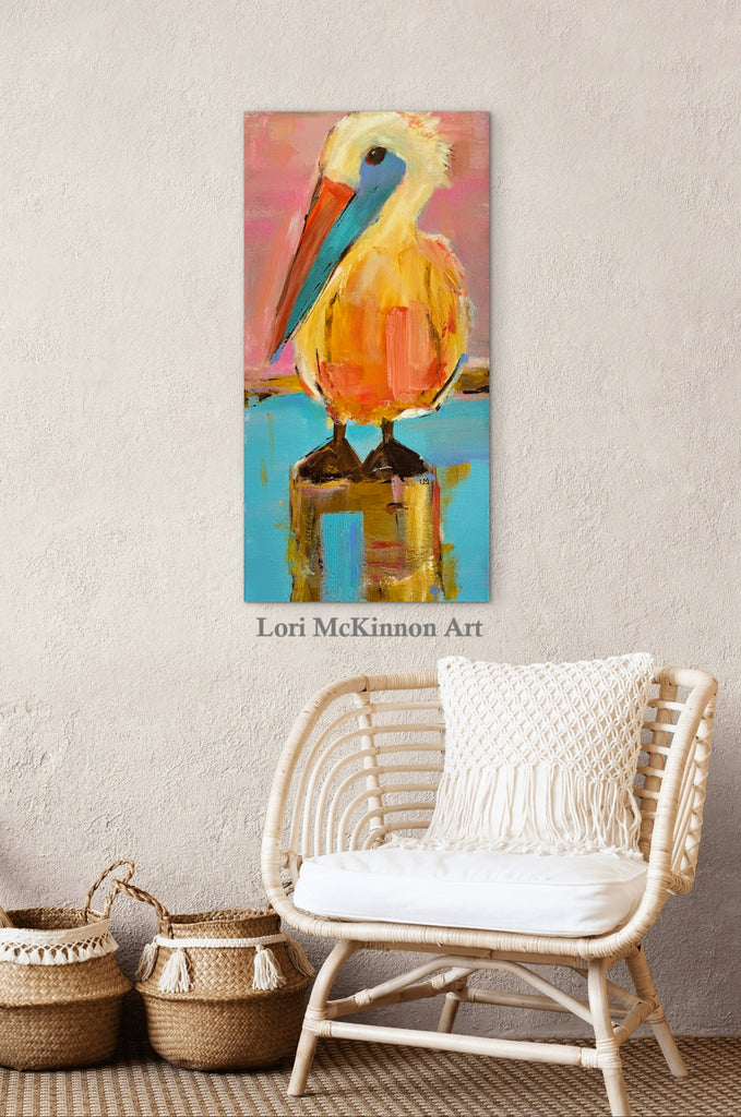 pelican art on a wall above a wicker chair with a white cushion and blanket with 2 jogs on the floor next to it