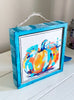 pumpkin artwork in a wood frame painted white and blue with a jute rope hanger or can stand alone on a table