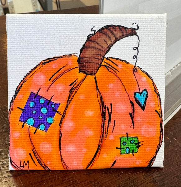 Painted pumpkin with colorful patterns on a white background