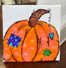 Painted pumpkin with colorful patterns on a white background
