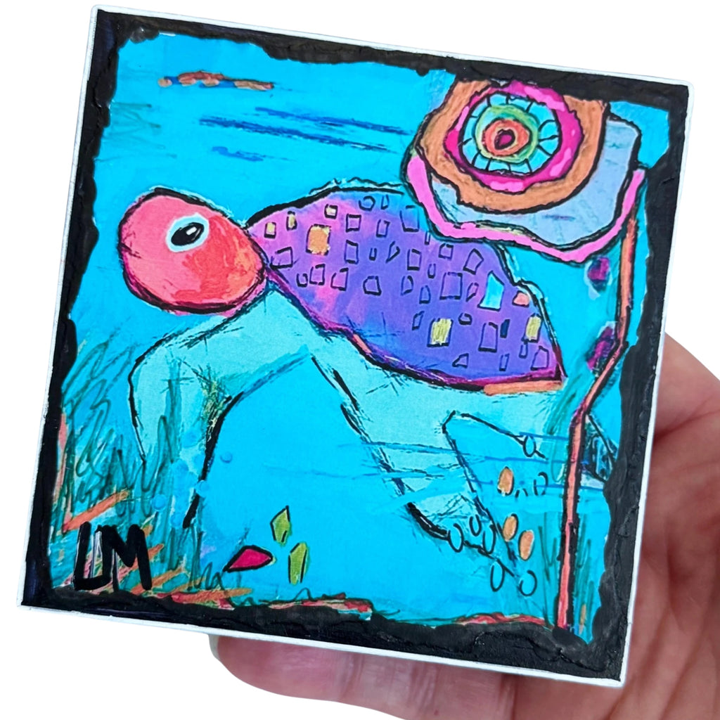 a sea turtle painting being held by a hand with a white background