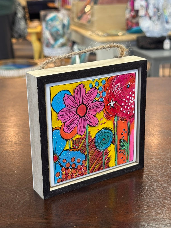 floral painting in wood frame