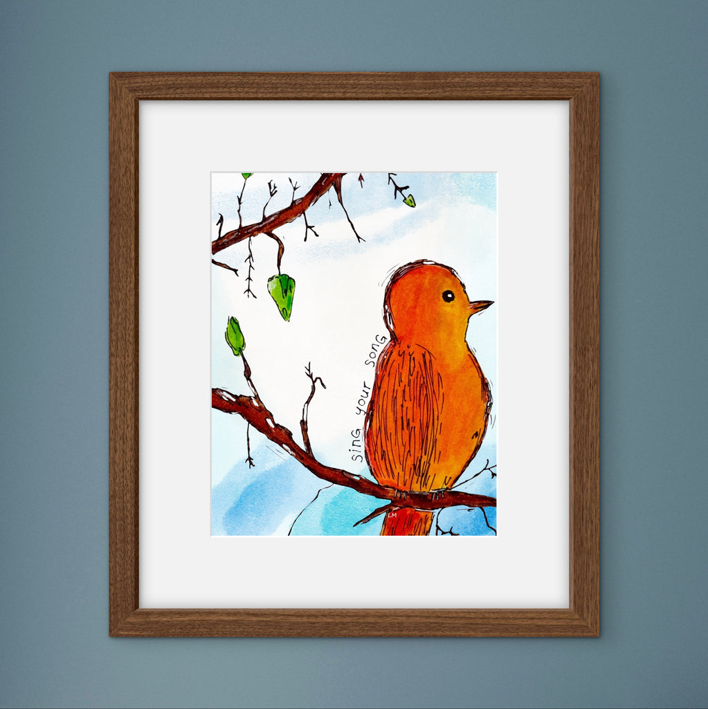 Framed artwork of a bird on a branch with a blue sky background