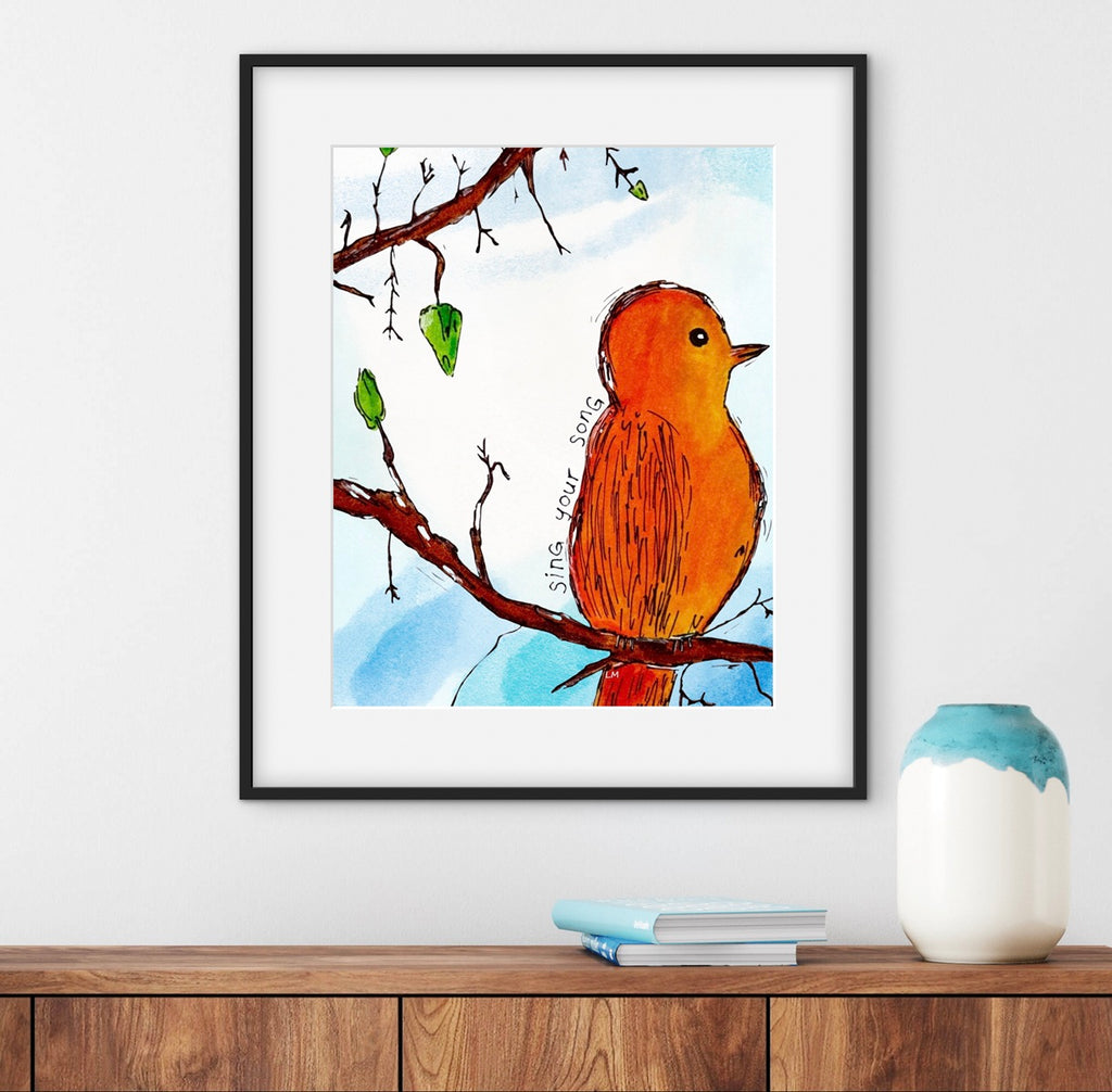 framed artwork of orange bird on branch