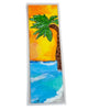 beach scene painted on a laminated bookmark with a sunset sky and a palm tree, Initials for the artist 'LM' on lower corner