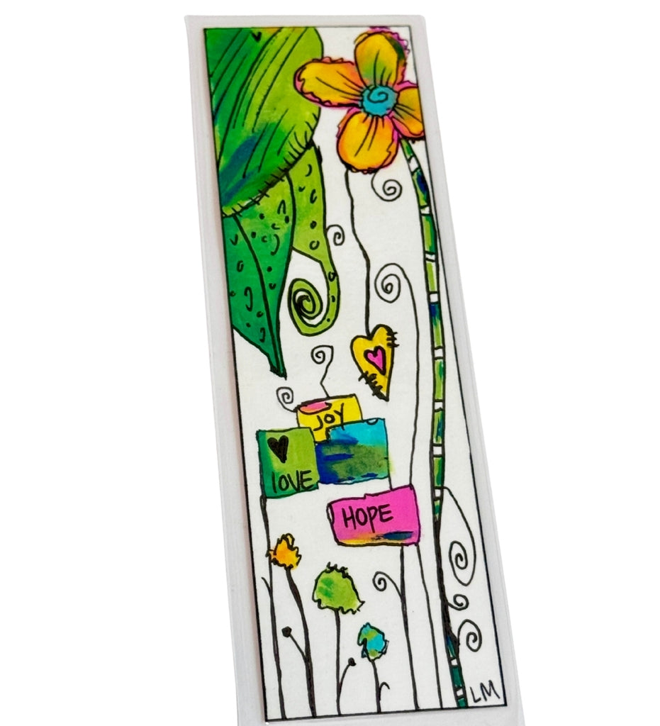 A rectangular bookmark featuring a colorful whimsical illustration with a large yellow flower, green leaves, black swirling stems, and small signs reading 'LOVE', 'PEACE', 'HOP', and 'HOPE' on a white background.