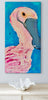 roseate spoonbill artwork on a white wall above a table with a seashell shaped bowl
