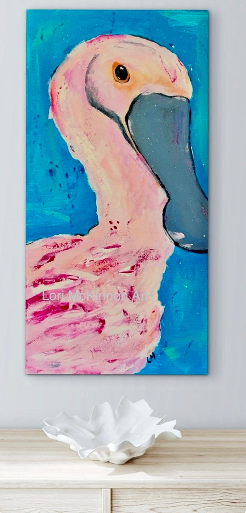 roseate spoonbill artwork on a white wall above a table with a seashell shaped bowl