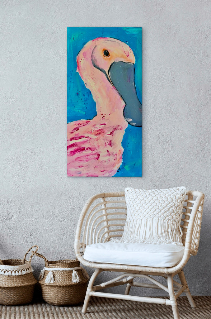 roseate spoonbill wall art on a grey wall over a chair and two vases