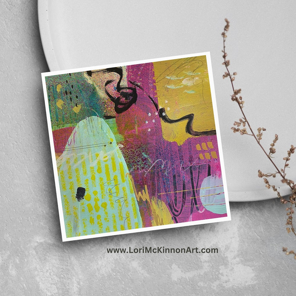 Abstract artwork with colorful shapes and patterns on a gray surface.