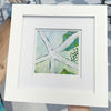 Framed artwork of a starfish with green and blue colors.