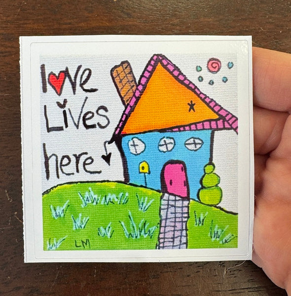 Colorful sticker of a house with 'Love Lives here' text 