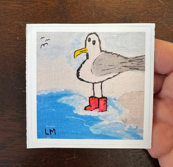 sticker with a seagull wearing red boots on a wooden surface